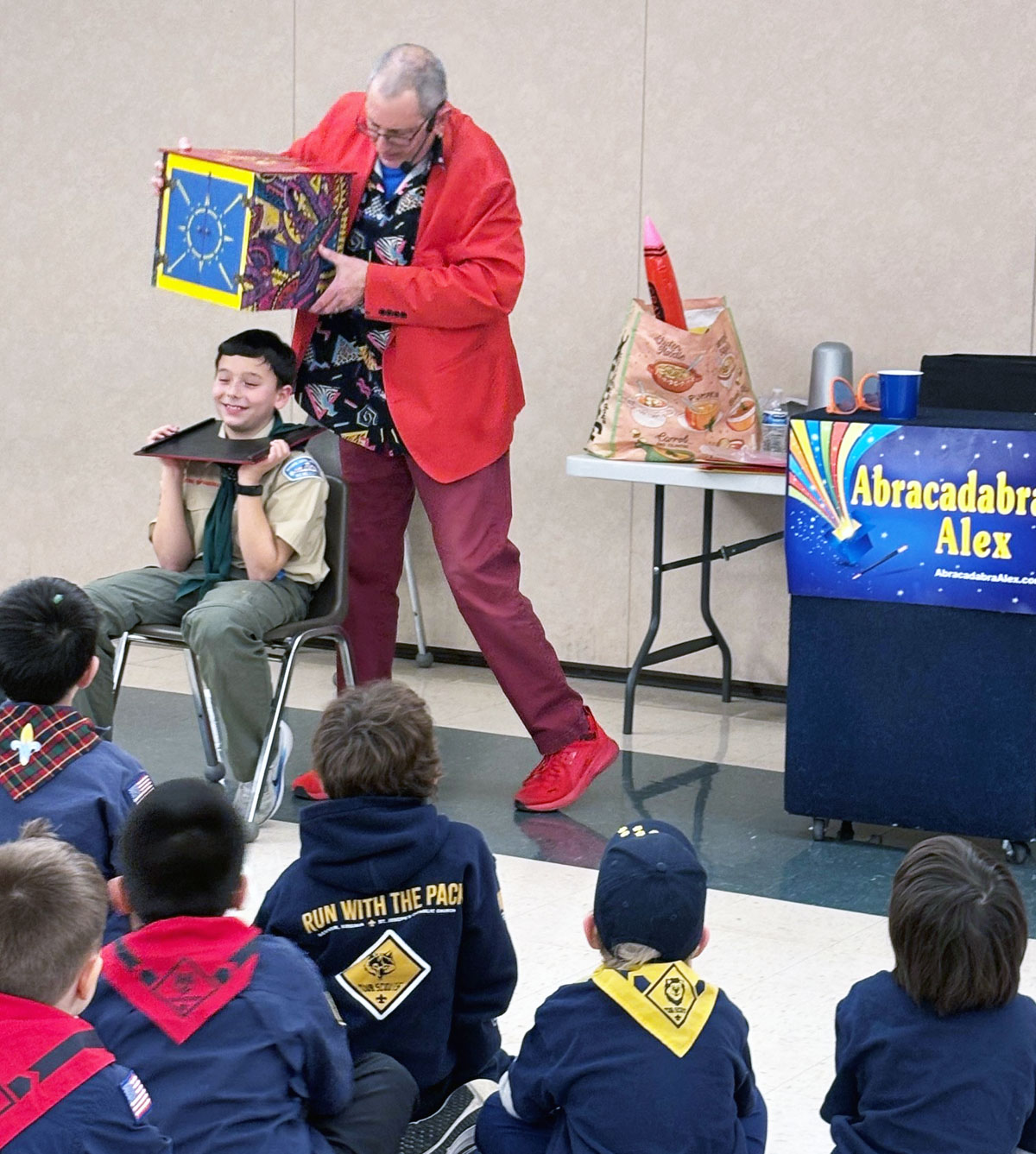 Blue and gold banquet magician Abracadabra Alex performs magic